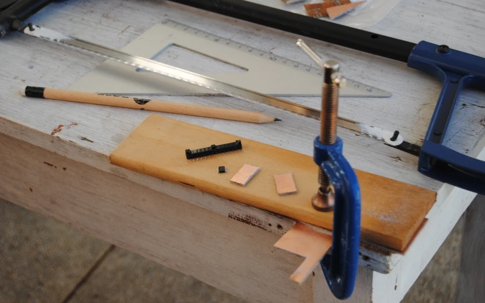 Cutting a PCB plate into two small rectangles, using a metal saw.